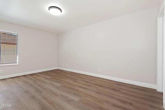 spare room featuring wood-type flooring