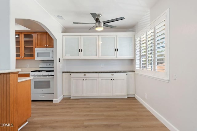 kitchen with white cabinetry, white appliances, light hardwood / wood-style flooring, and ceiling fan