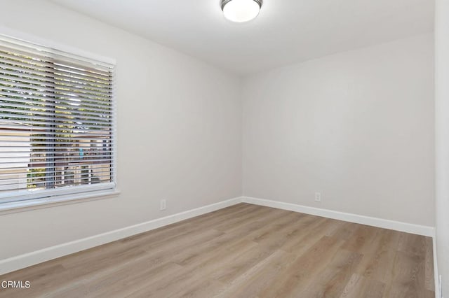 unfurnished room with light hardwood / wood-style floors