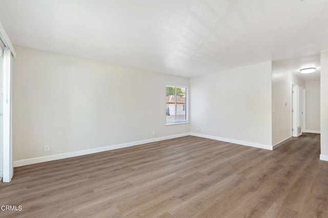 spare room with hardwood / wood-style floors