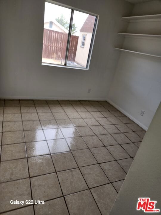 empty room with light tile patterned floors