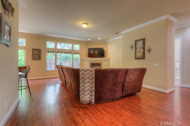 living room with crown molding and hardwood / wood-style floors