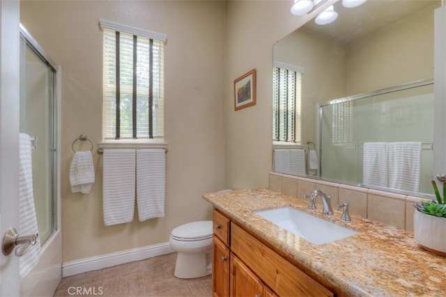 full bathroom with a wealth of natural light, tile patterned flooring, vanity, and toilet