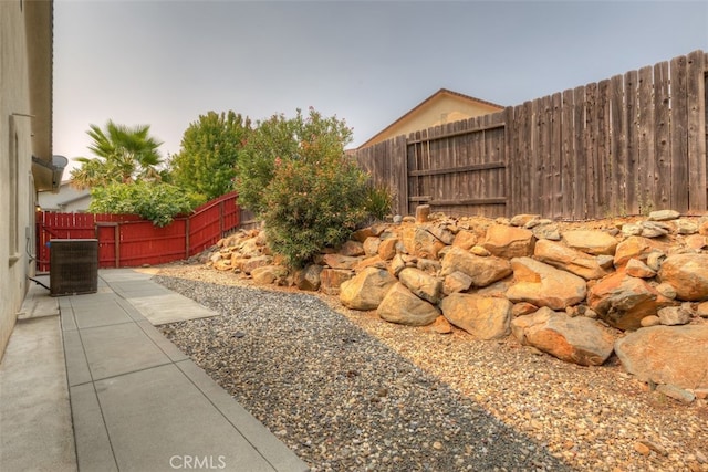 view of yard featuring central AC and a patio area