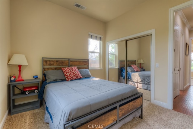 bedroom with light wood-type flooring and a closet