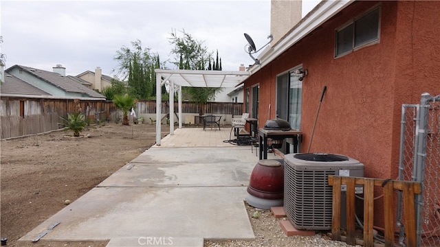 view of patio with a pergola and central AC