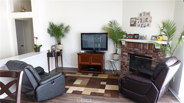 living room with dark hardwood / wood-style floors and a fireplace