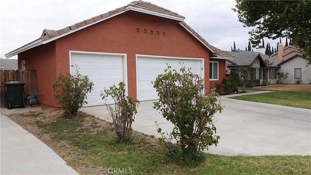 view of front of house featuring a garage and a front lawn