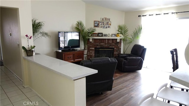 tiled living room featuring a fireplace