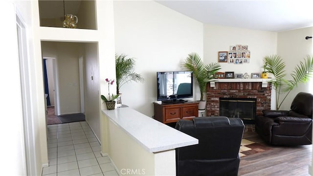 tiled living room with a brick fireplace