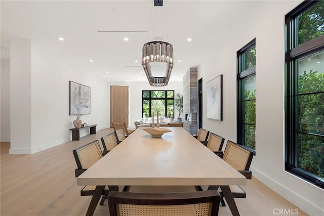 dining room featuring light wood-type flooring and a chandelier