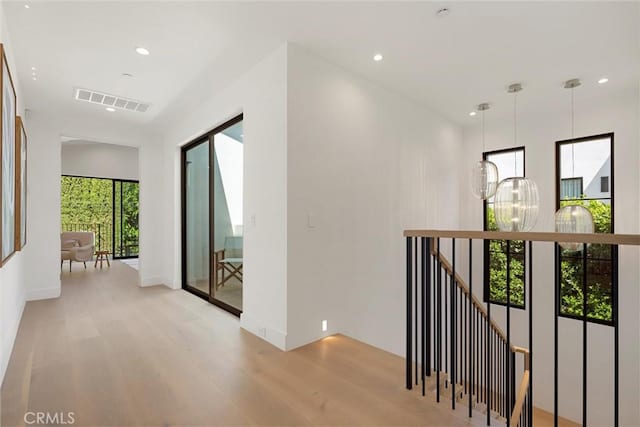 hallway with light hardwood / wood-style flooring