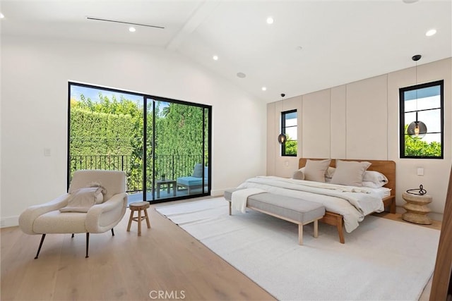 bedroom featuring access to exterior, hardwood / wood-style floors, and lofted ceiling with beams