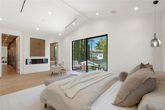 bedroom featuring access to exterior, vaulted ceiling with beams, and light hardwood / wood-style floors