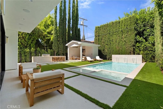 view of swimming pool featuring an outdoor living space, a patio area, and an outdoor structure