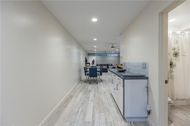 kitchen featuring white cabinetry, ceiling fan, and light hardwood / wood-style floors