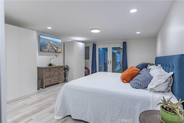 bedroom with access to outside, light hardwood / wood-style flooring, and french doors