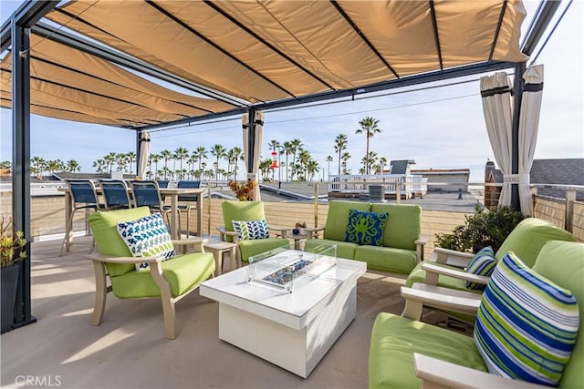 view of patio / terrace with an outdoor living space with a fire pit