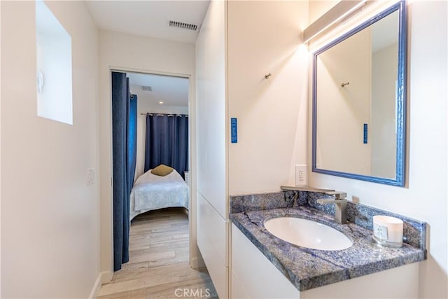 bathroom with vanity and hardwood / wood-style flooring