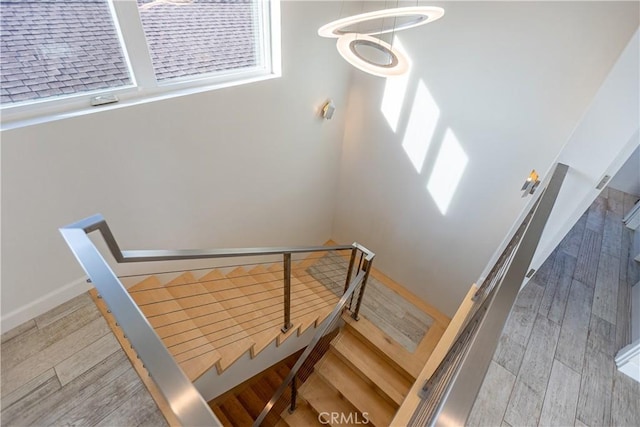 stairway featuring wood-type flooring