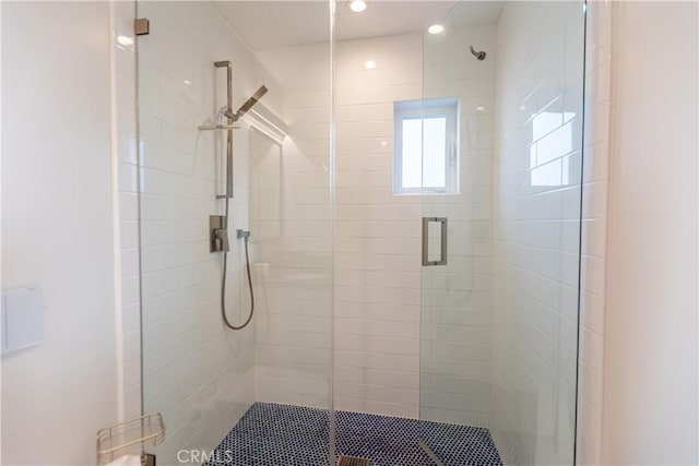 bathroom featuring a shower with door