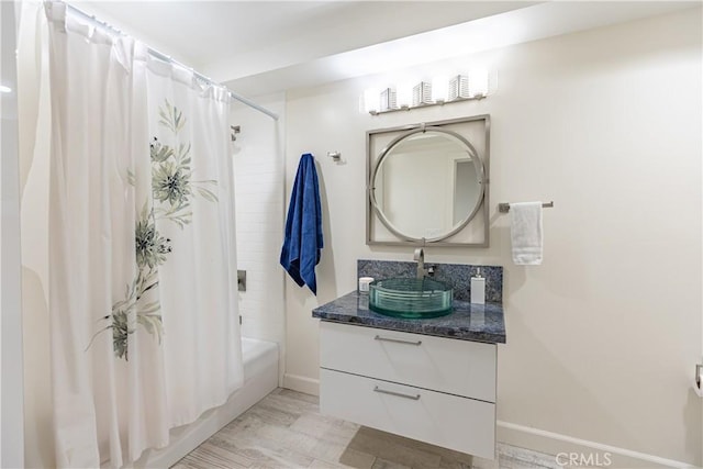 bathroom with shower / bathtub combination with curtain and vanity