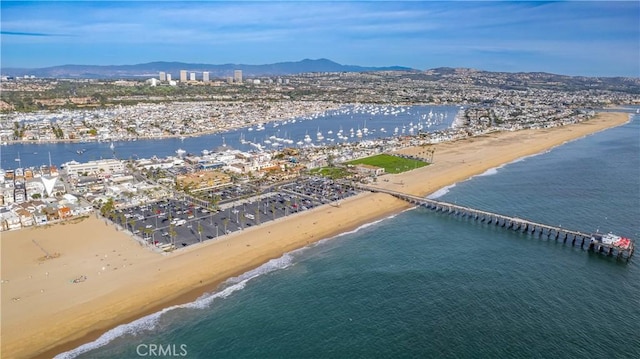 aerial view with a water and mountain view and a beach view