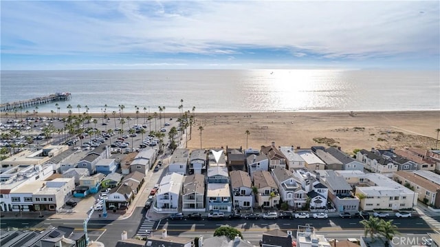 drone / aerial view featuring a water view and a beach view