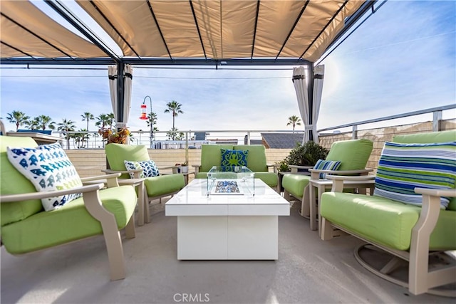 view of patio / terrace featuring an outdoor living space with a fire pit