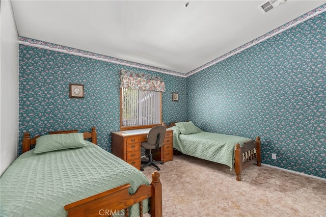 bedroom featuring visible vents, wallpapered walls, and carpet