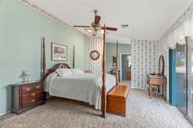 carpeted bedroom featuring baseboards, visible vents, wallpapered walls, a ceiling fan, and crown molding