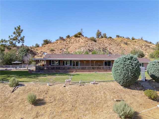 rear view of property featuring a lawn