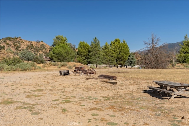 view of yard featuring a mountain view and a rural view
