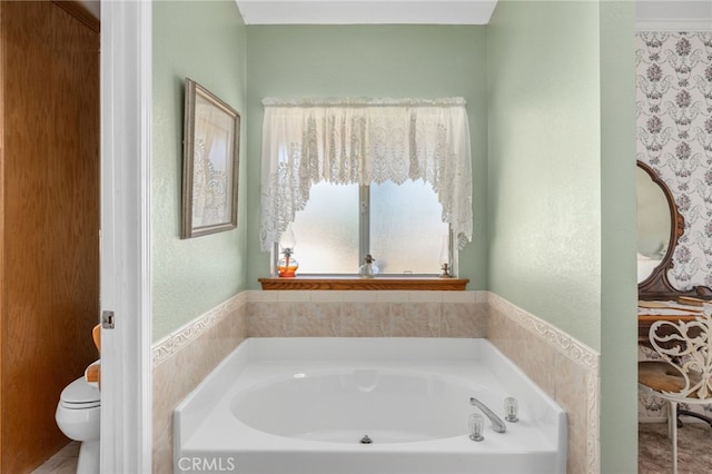 full bath featuring a garden tub and toilet