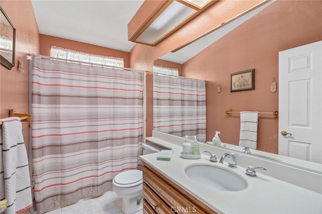 bathroom with tile patterned flooring, vanity, and toilet