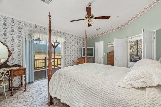 bedroom featuring crown molding, wallpapered walls, visible vents, and access to exterior