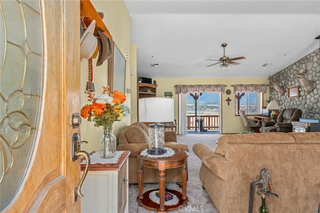 carpeted living area with a ceiling fan and visible vents