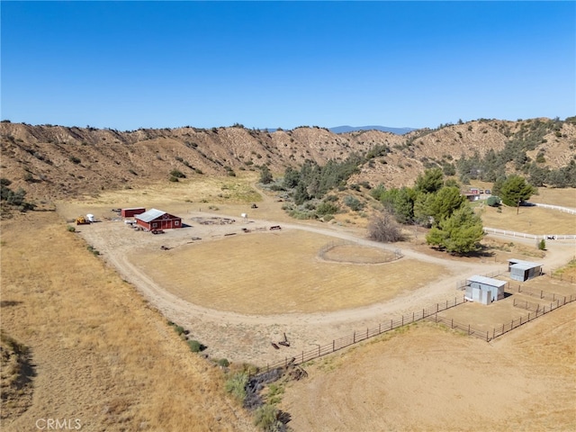 birds eye view of property featuring a mountain view and a rural view