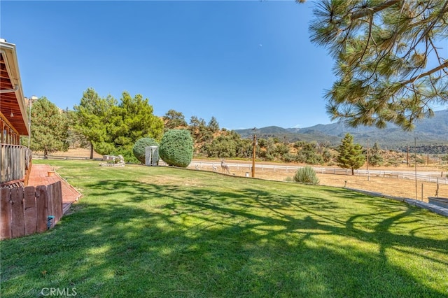 view of yard with a mountain view and fence