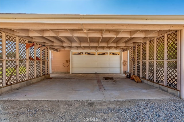 garage with driveway and fence