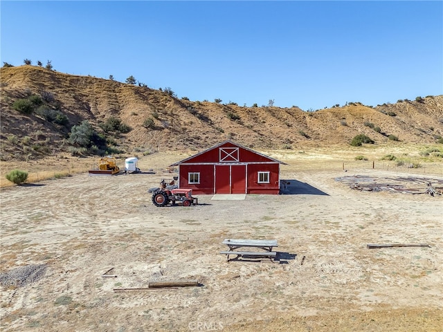 view of outbuilding featuring a mountain view