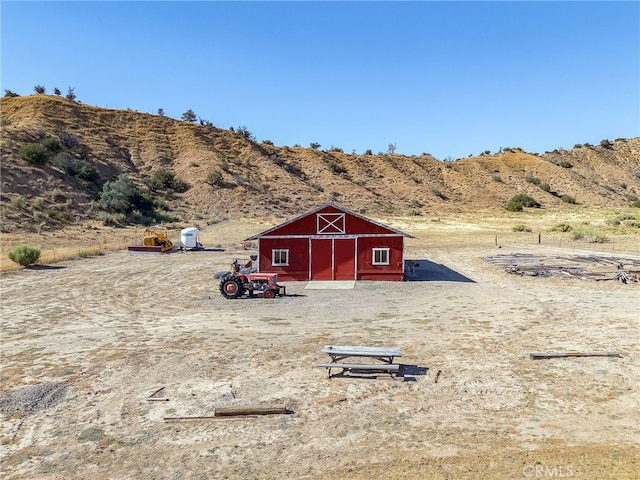 exterior space featuring a mountain view, an outbuilding, and a barn