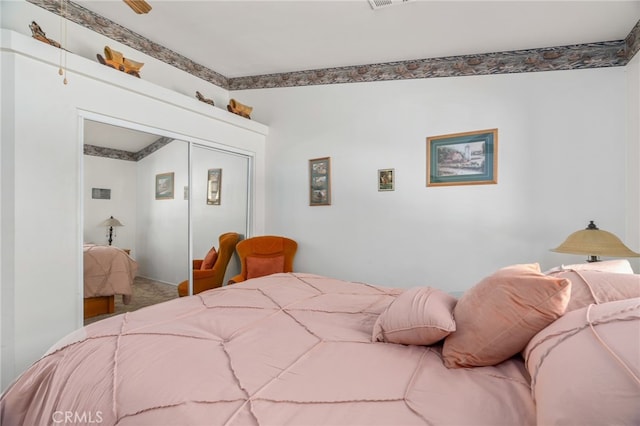 bedroom with carpet floors, visible vents, and a closet