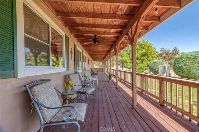 wooden deck featuring ceiling fan