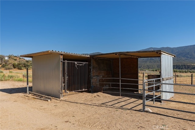 view of horse barn with a mountain view