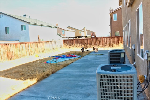 view of patio featuring cooling unit and a fenced backyard