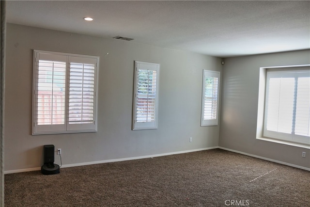 unfurnished room featuring recessed lighting, visible vents, baseboards, and carpet