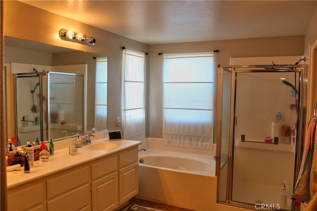 bathroom featuring vanity, plus walk in shower, and a textured ceiling