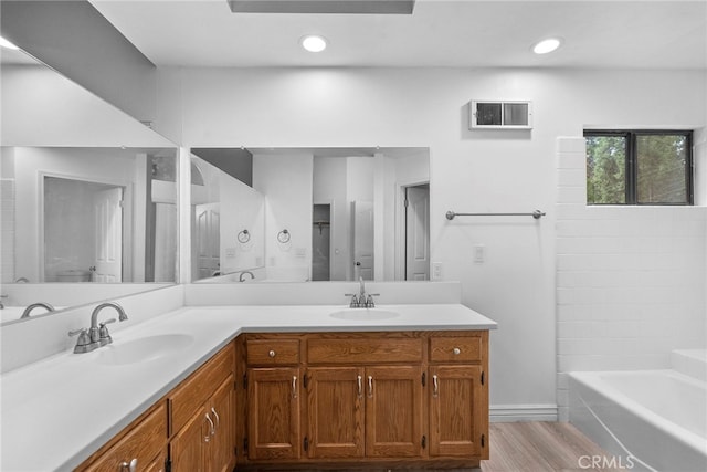 bathroom featuring independent shower and bath, vanity, and wood-type flooring