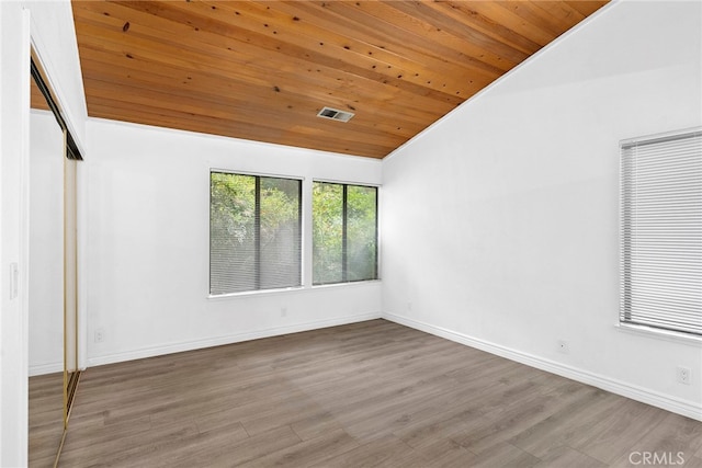 unfurnished room with wood ceiling, hardwood / wood-style floors, and vaulted ceiling